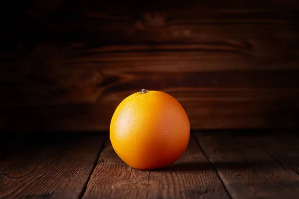 Fresh orange on a wooden table — Stock Photo, Image