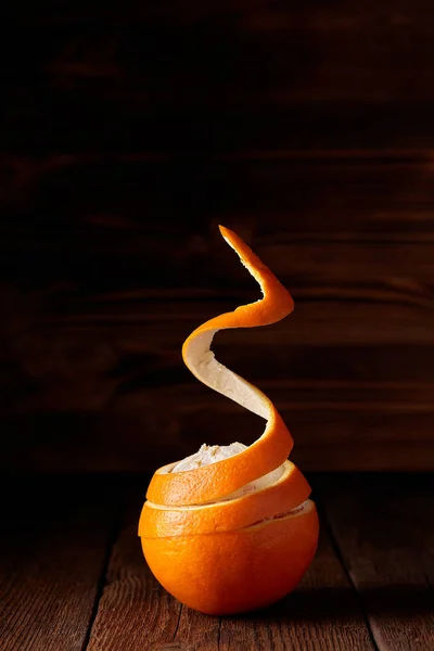 A flying peeled orange on the wooden background — Stock Photo, Image