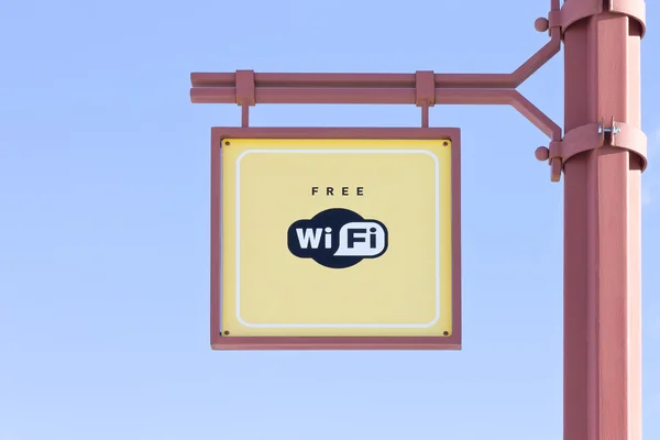 Free WiFi - wireless internet sign on blue sky background — Stock Photo, Image