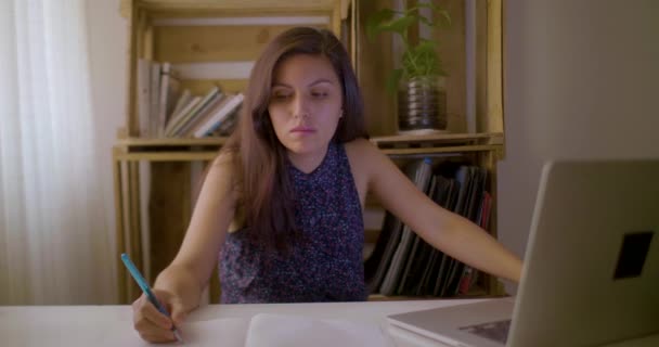 Young Hispanic Woman Sitting Desk Checks Her Notes Writes — Stock Video