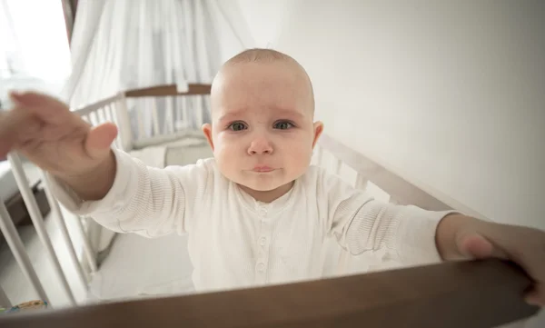 Small abandoned baby in the crib crying — Stock Photo, Image