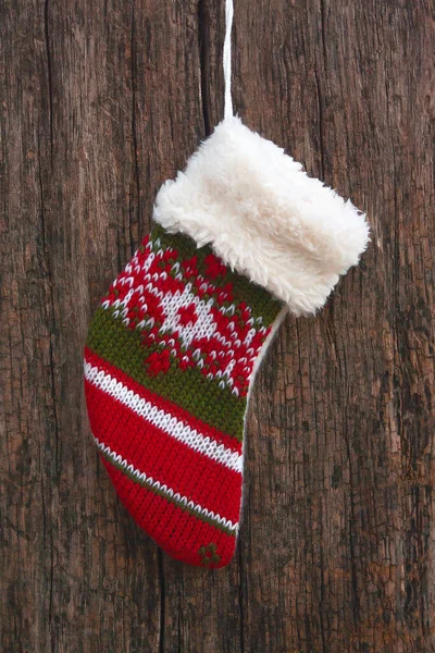 christmas sock on dark wooden background. christmas stocking hanging over rustic wooden background. Holidays decoration