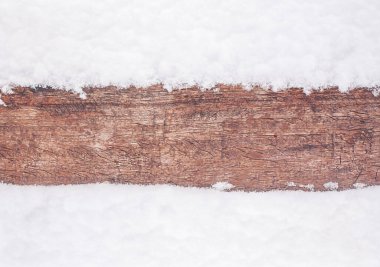 Karların ortasında doğal bir odun şeridi. Doğal kış ağacı arka planı.