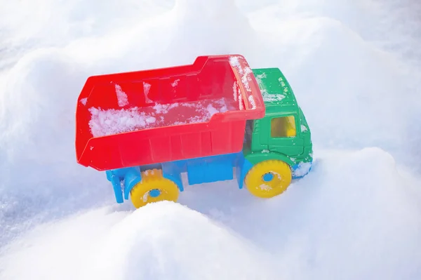 bright toy truck on natural snow on outdoor
