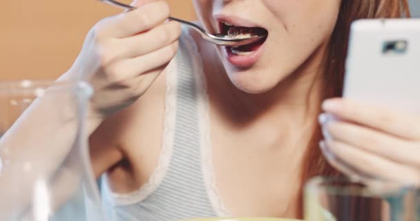 Mujer con smartphone desayunando sano — Vídeos de Stock