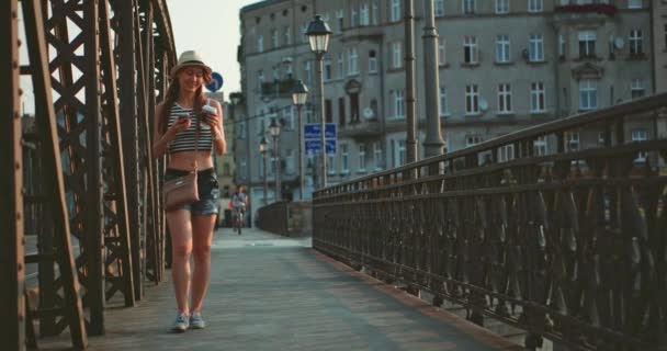 Woman using smartphone and drinking coffee — Stock Video