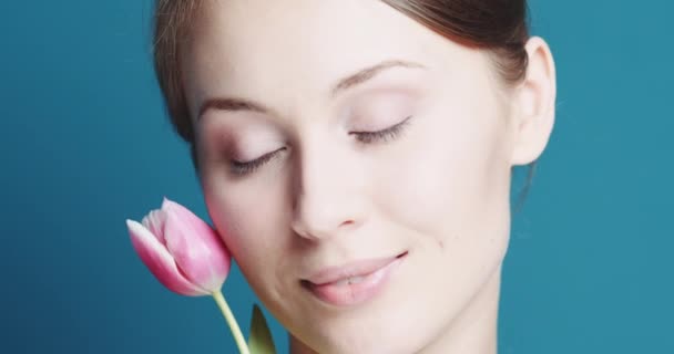 Hermosa mujer con tulipán rosa — Vídeos de Stock