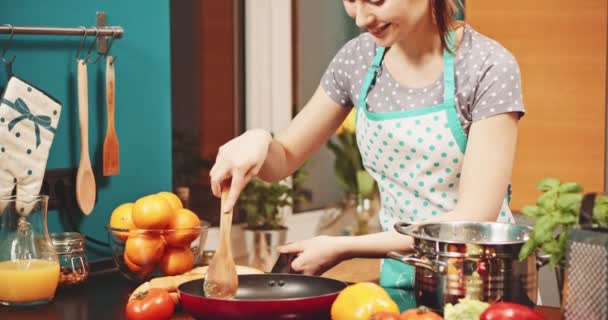 Женщина готовит еду на сковородке — стоковое видео