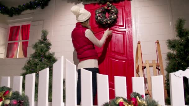 Young woman is decorating the front door — Stock Video