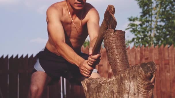 Joven hombre fuerte cortando madera — Vídeos de Stock