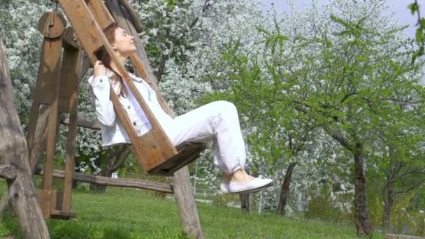 Young cheerful woman on swings — Stock Video