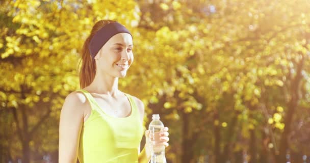 Athletic beautiful sports woman drinking — Stock Video