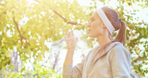 Athletic beautiful sports woman drinking — Stock Video