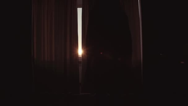 Woman with slender body opens curtains — Stock Video