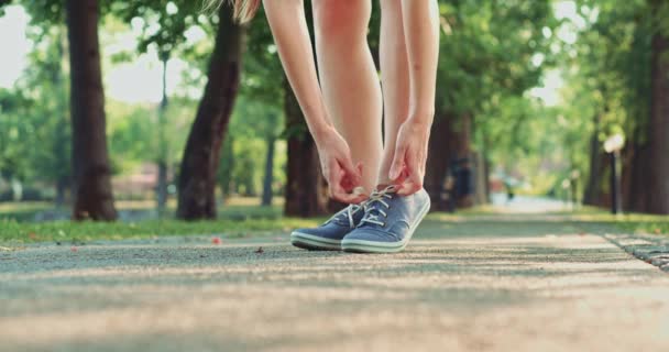 Mujer atando sus zapatos de goma — Vídeos de Stock