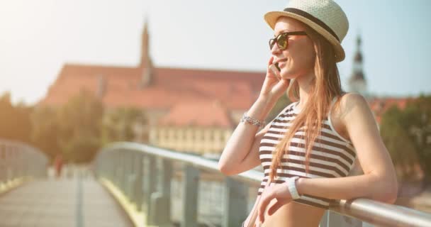 Woman using smartphone in European city — Stock Video