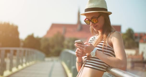 Woman using smartphone in European city — Stock Video