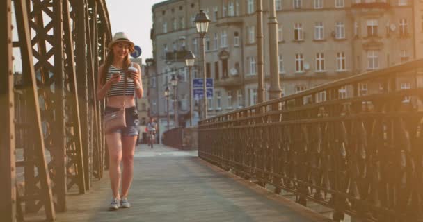 Woman using smartphone and drinking coffee — Stock Video