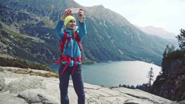 Hiker woman making selfie with smartphone — Stock Video