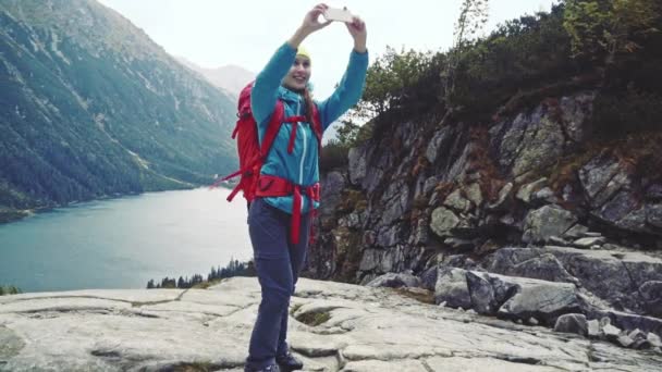 Hiker woman making selfie with smartphone — Stock Video