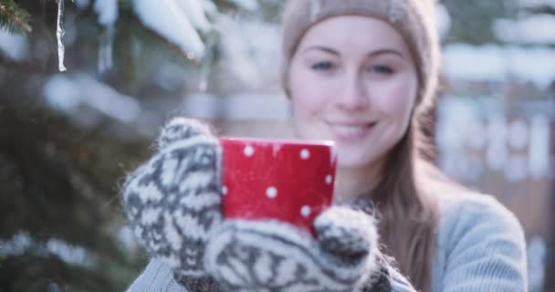 Woman offering hot tea at winter — Stock Video