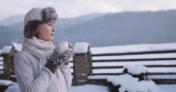 Woman drinking tea or coffee in mountains — Stock Video