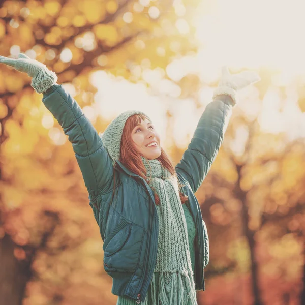 Happy young woman in the autumn park Stock Image