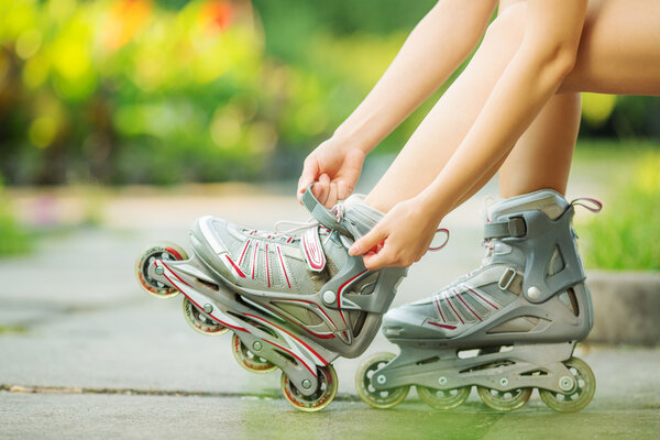 Woman putting on inline skates