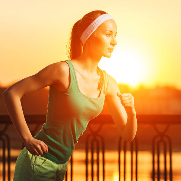 Woman running in city on quay