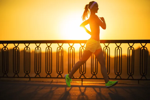 Woman running in city on quay — Stock Photo, Image