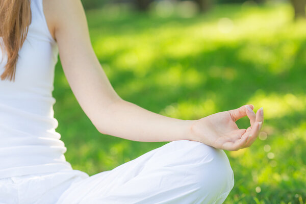 Woman meditating in lotus position.