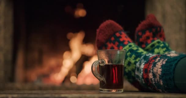 Woman relaxes by warm fire — Stock Video