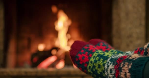 Woman relaxes by warm fire — Stock Video