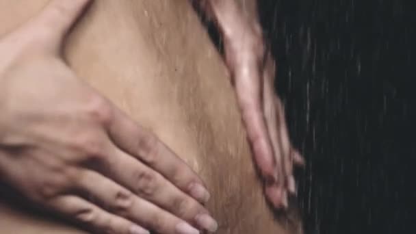 Woman standing under pouring water — Stock Video