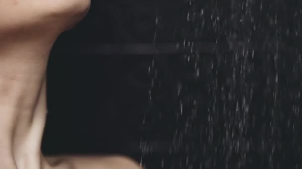 Woman standing under pouring water — Stock Video