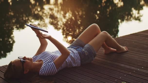 Femme utilisant une tablette numérique à l'extérieur 