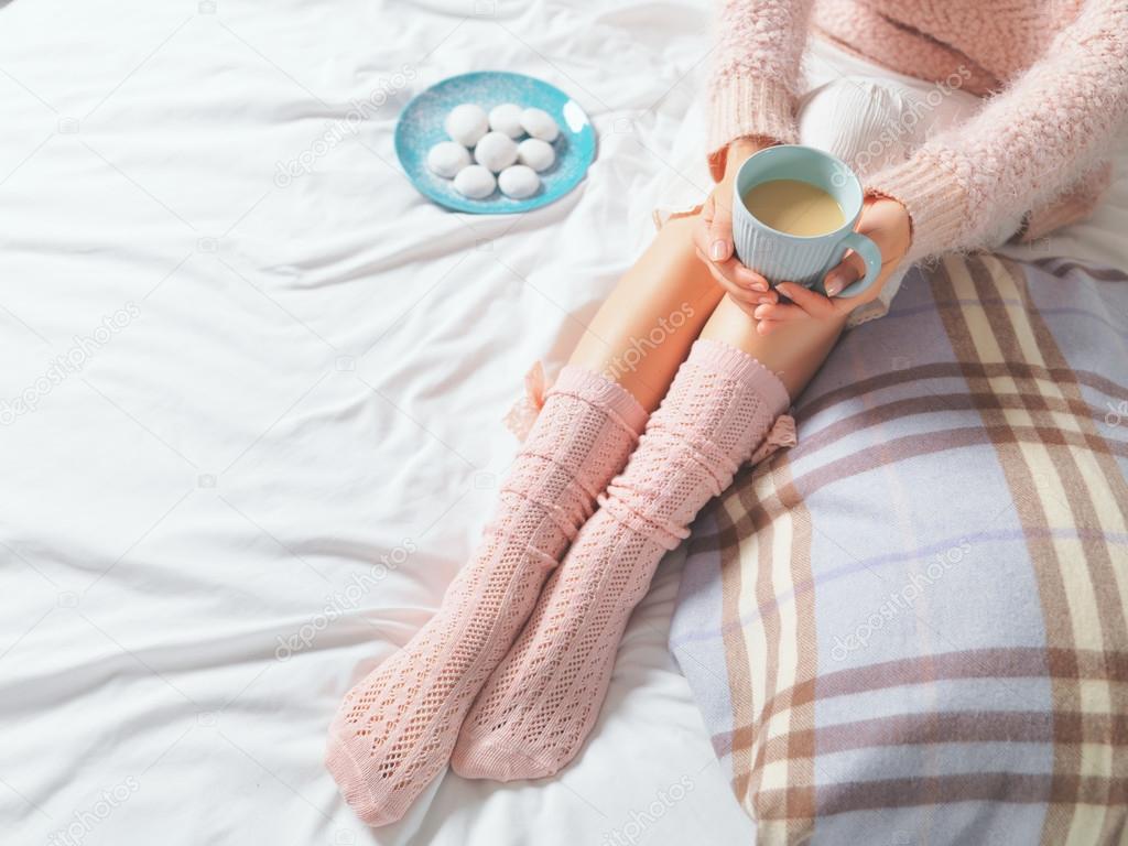 Woman relaxing at cozy home atmosphere