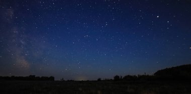 Sıcak bir yaz gecesinde yıldızlı gece gökyüzü. Samanyolu. 