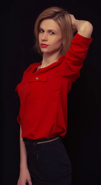 Beautiful young girl stands on a black background — Stock Photo, Image