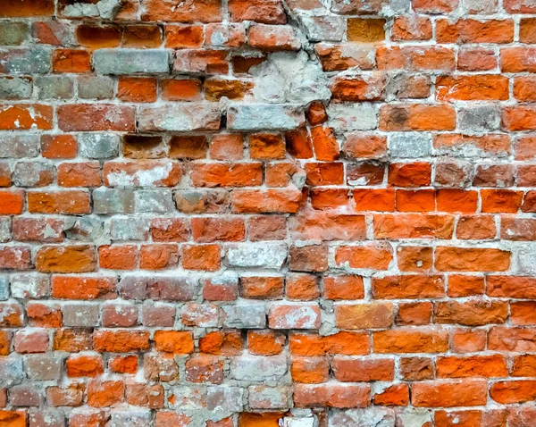 レンガの背景としての亀裂の壁の破損 — ストック写真