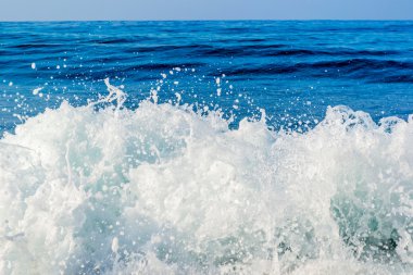 Waves on the sea and blue sky horizon