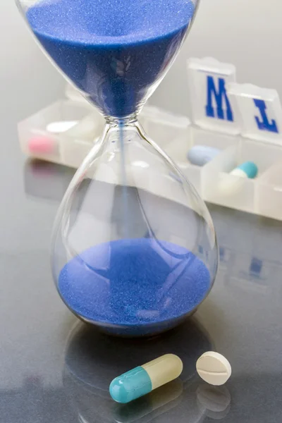 Some pills and red clock, daily medication treatment — Stock Photo, Image