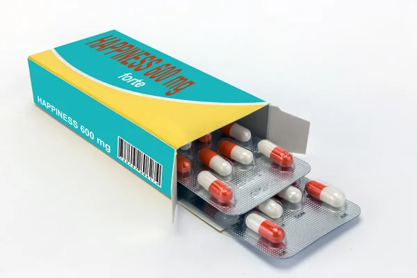 Open medicine packet labelled happiness opened at one end to dis — Stock Photo, Image