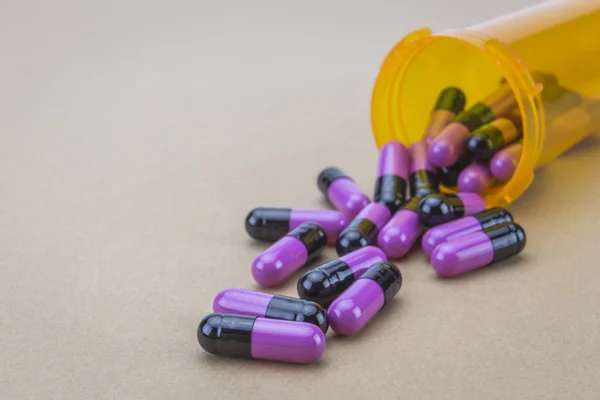 Pills spilling from an open bottle — Stock Photo, Image