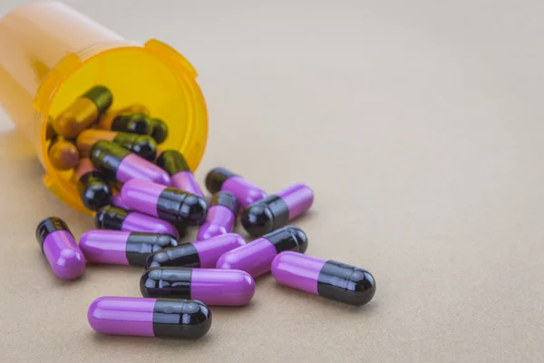 Pills spilling from an open bottle — Stock Photo, Image