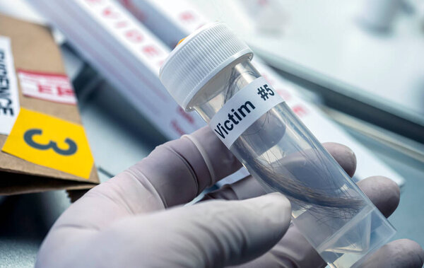 Ученый полиции держит в руках бутылку волос жертвы убийства в криминалистической лаборатории, концептуальное изображение