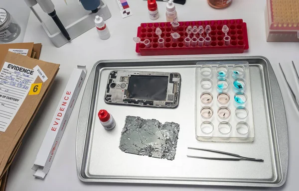 pieces of burnt smartphone involved in lab murder, concept image