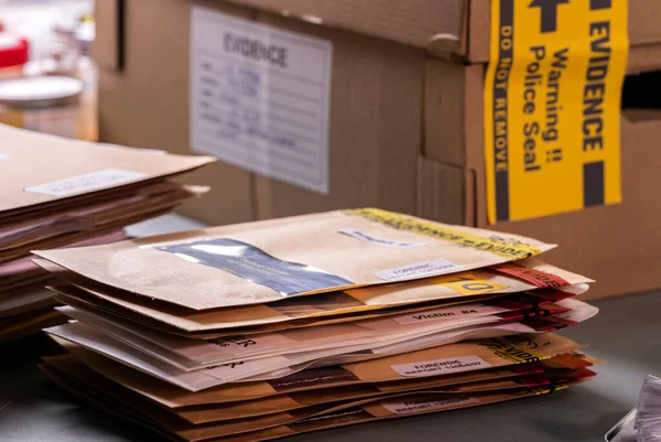 Files and evidence bag in a crime lab, conceptual image