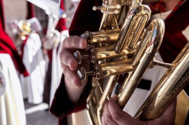 Penitents playing trumpets during Holy week in the good Friday clipart