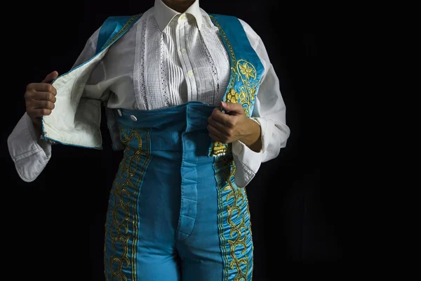 Woman bullfighter by dressing with vest on your back on a black — Stock Photo, Image